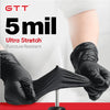 A hand wearing a black disposable glove is stretching a black fabric, demonstrating the Ultra Stretch feature.
