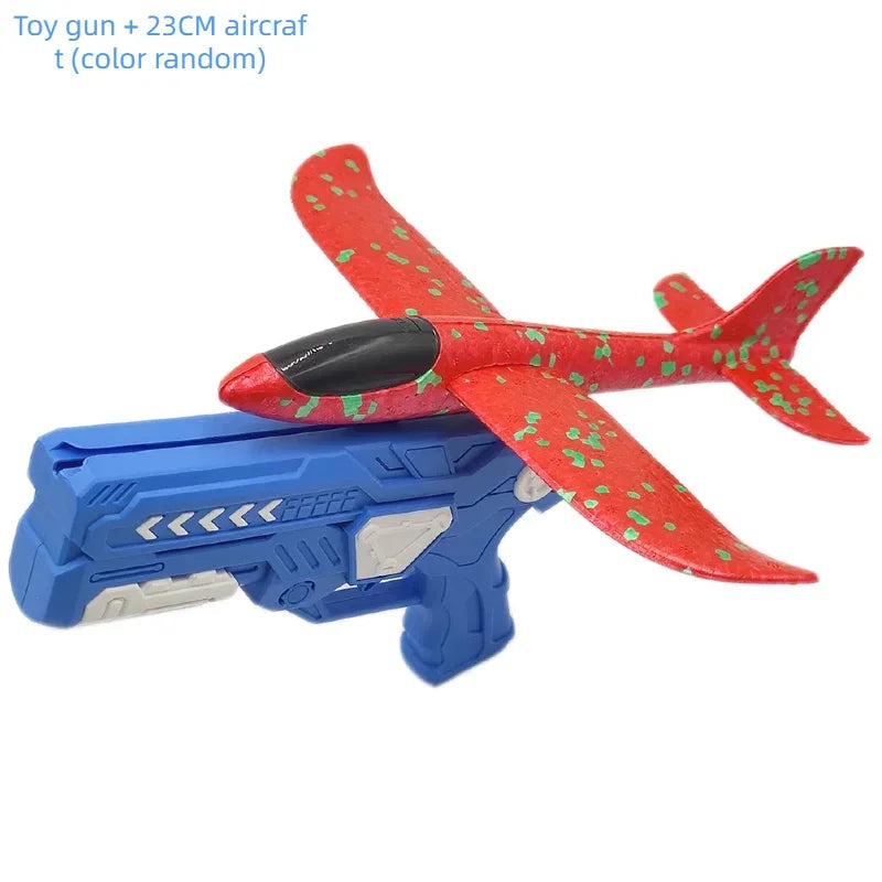 A red and green foam glider airplane toy gun with a blue launcher, designed for kids.