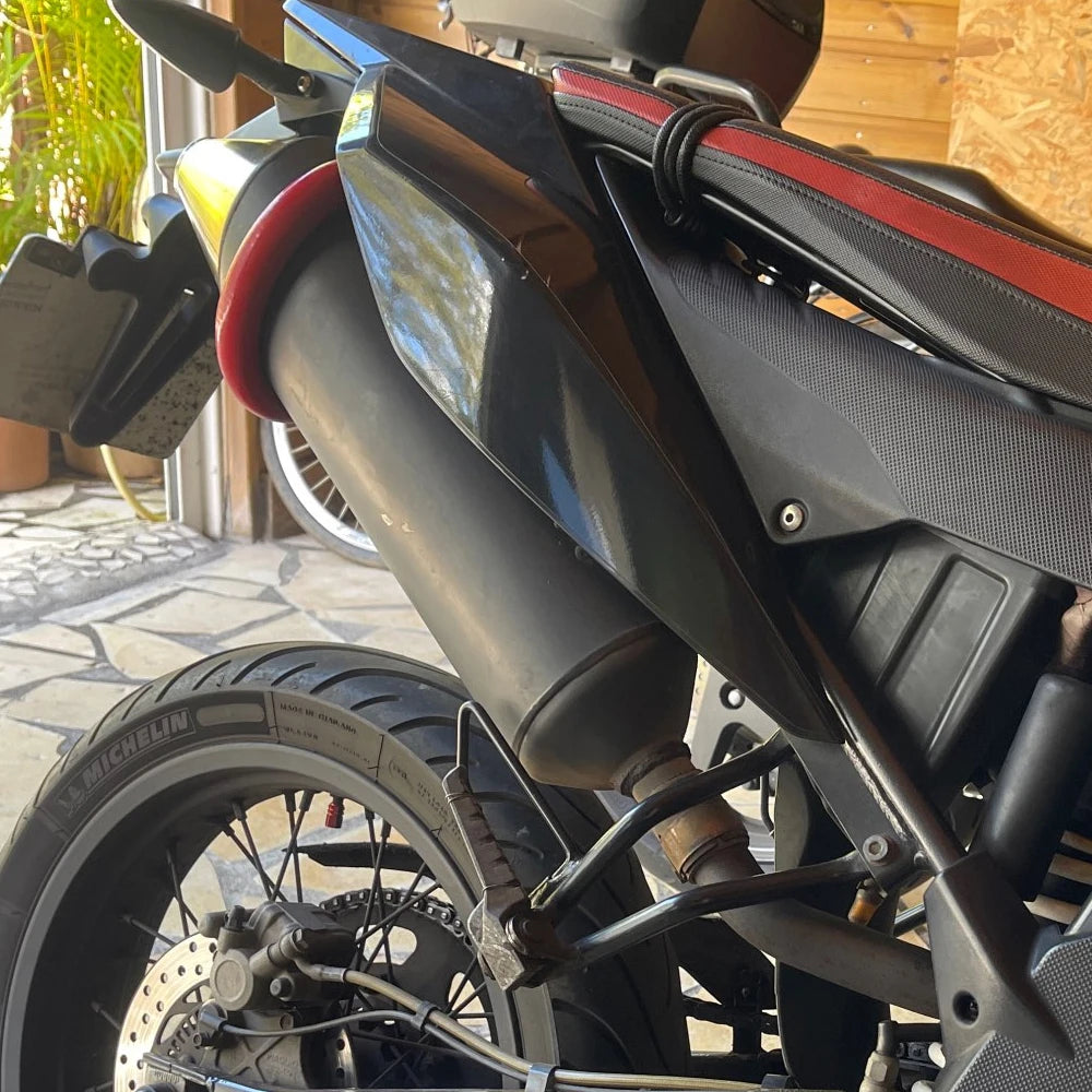 Close-up view of a universal dirt bike exhaust guard on a motorcycle.