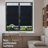 A window fitted with black cordless retractable roller shades in a modern interior setting.