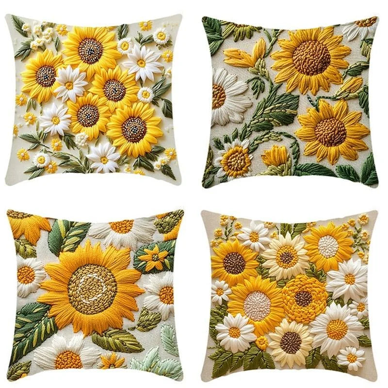 A set of fabric cushion covers featuring various designs of sunflowers and daisies in yellow, white, and green tones.