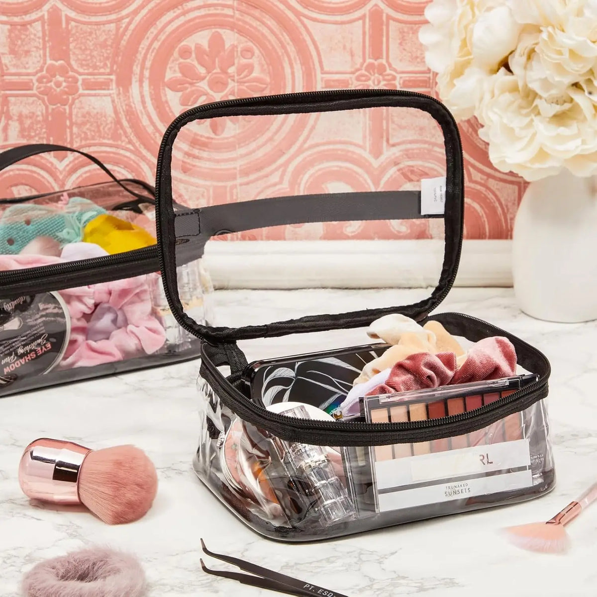 Clear transparent storage bag with zipper for toys, cosmetics & travel next to a brush.