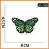 Five embroidered butterfly iron-on patches with green wings and yellow accents.