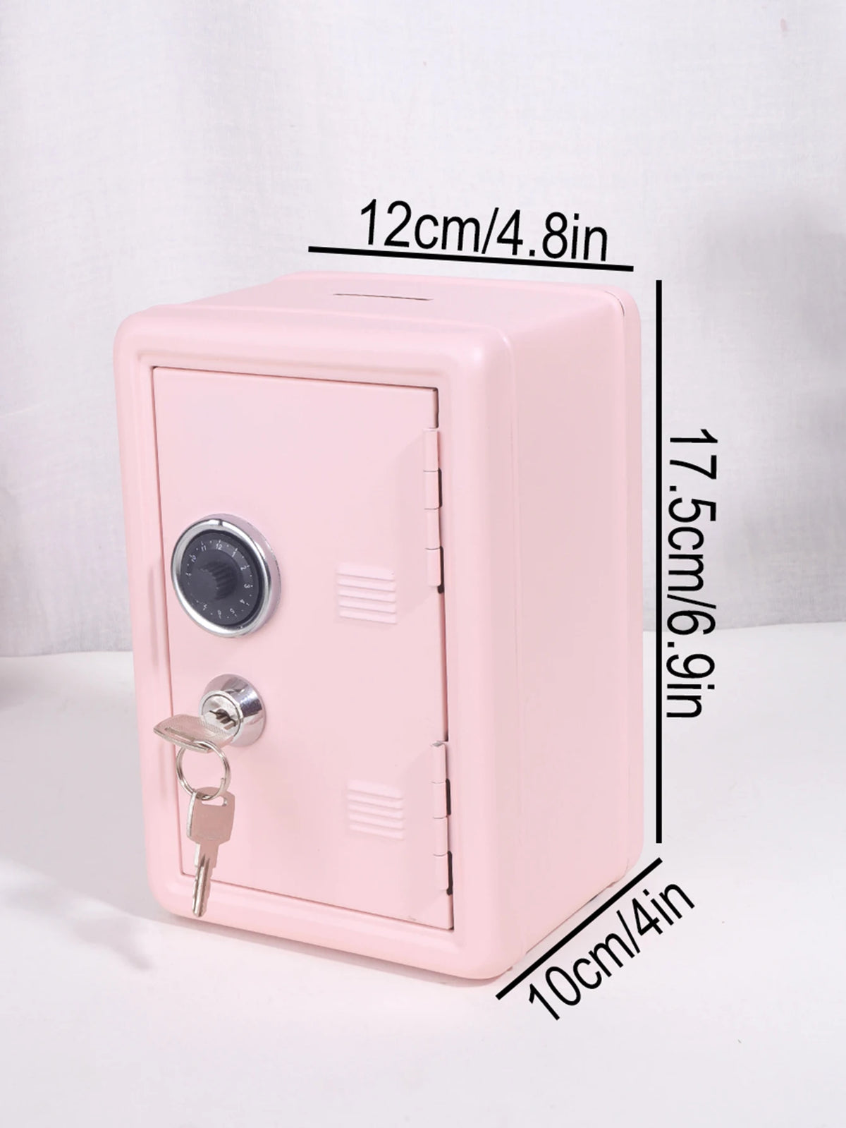 A pink vintage metal piggy bank with a combination lock and key, shown from the side.