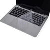 A clear TPU keyboard cover is placed on a closed MacBook Pro laptop.