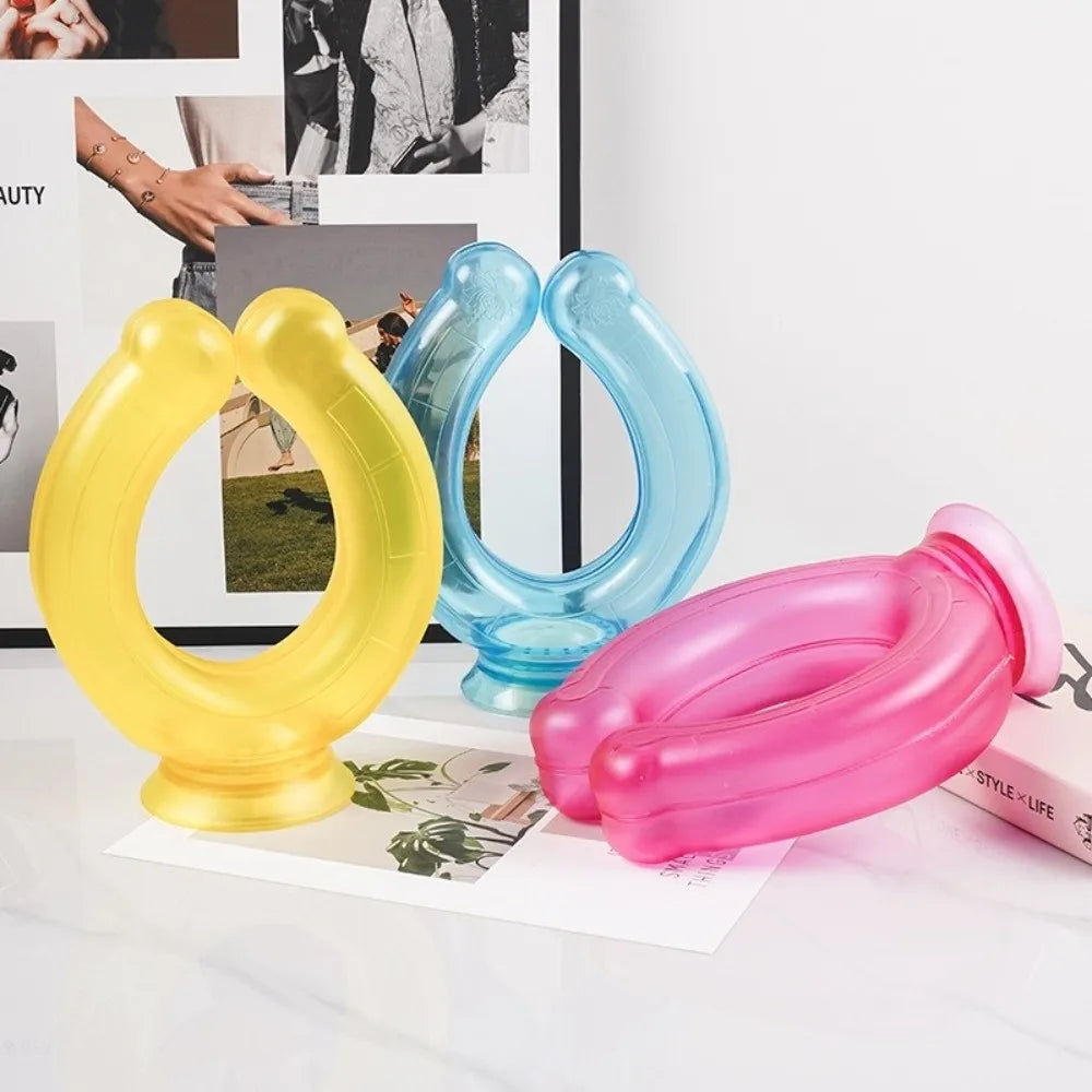 Three reusable U-shaped neck wraps in yellow, blue, and pink plastic resting on a white surface.