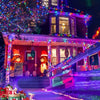 A brightly lit house facade decorated with colorful string lights and seasonal accents at night.
