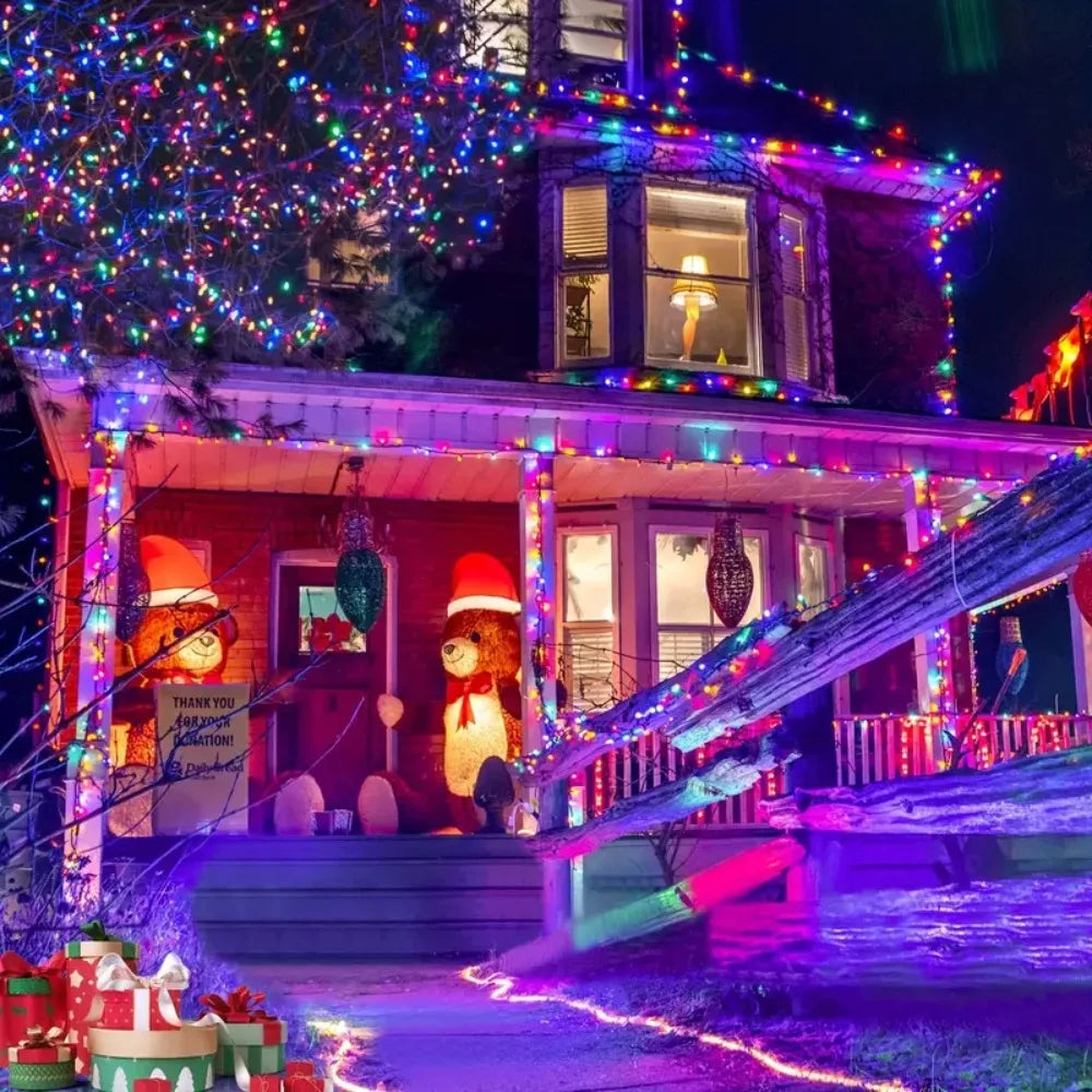 A brightly lit house facade decorated with colorful string lights and seasonal accents at night.
