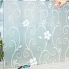 Frosted privacy window film with a white swirling floral pattern applied to glass.