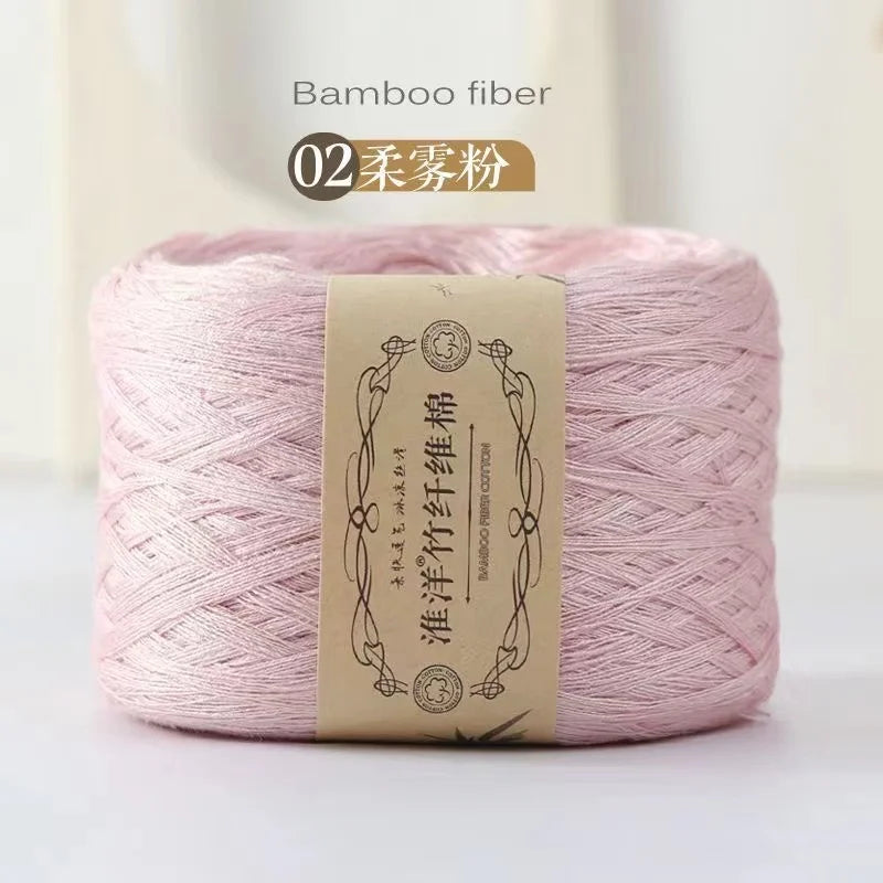 A spool of pink bamboo fiber yarn labeled as 02 Bamboo fiber for knitting and crochet.