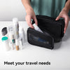 Hands open a black waterproof toiletry bag revealing various skincare products inside.