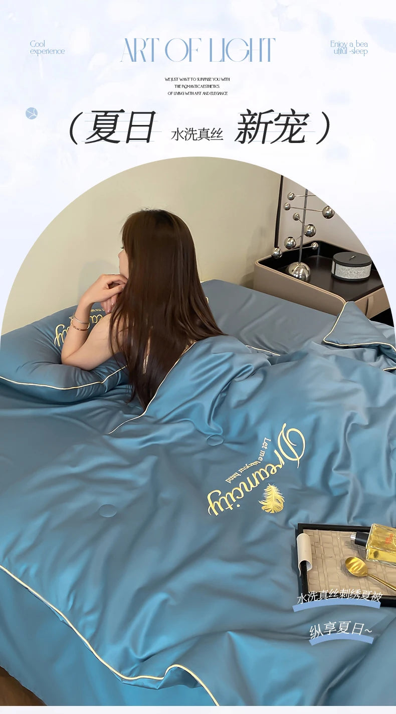A person is lying in a blue comforter with embroidery, suggesting a cool experience for sleep.