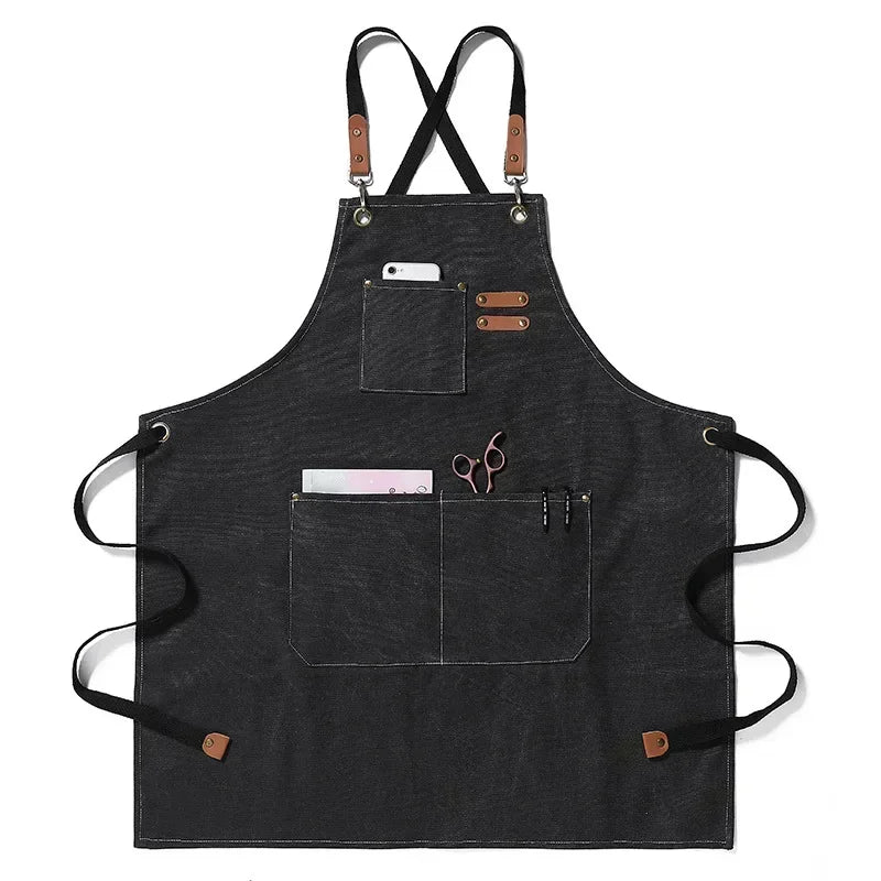 Black cotton canvas apron with cross-back straps and multiple pockets