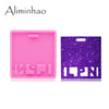 A pink silicone resin mold for badge backings and keychains, next to a purple glitter mold.