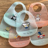 A collection of five adjustable soft silicone baby bibs featuring various cute cartoon animal prints in pastel colors.
