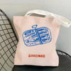 Pink canvas tote bag featuring a blue illustration of sardines.