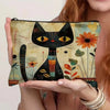 A black cat face design on a canvas storage pouch with floral accents.
