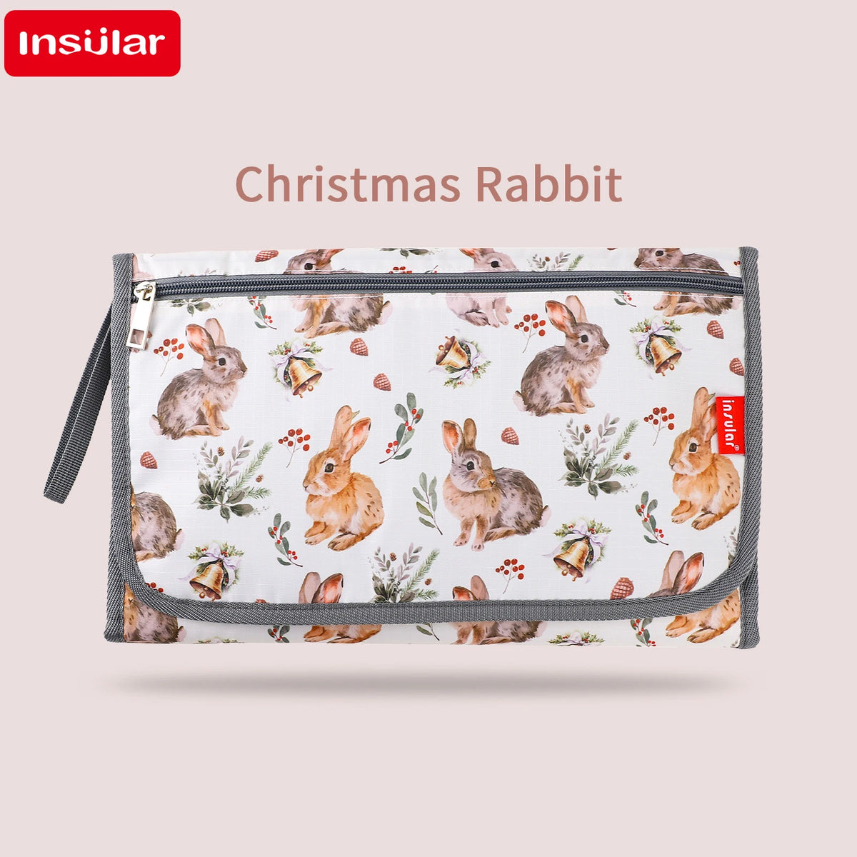 A portable baby changing mat with a waterproof cover and storage bag featuring a Christmas rabbit pattern.