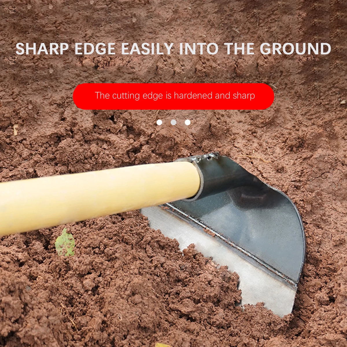 A stainless steel garden hoe is shown with its cutting edge inserted into brown soil.
