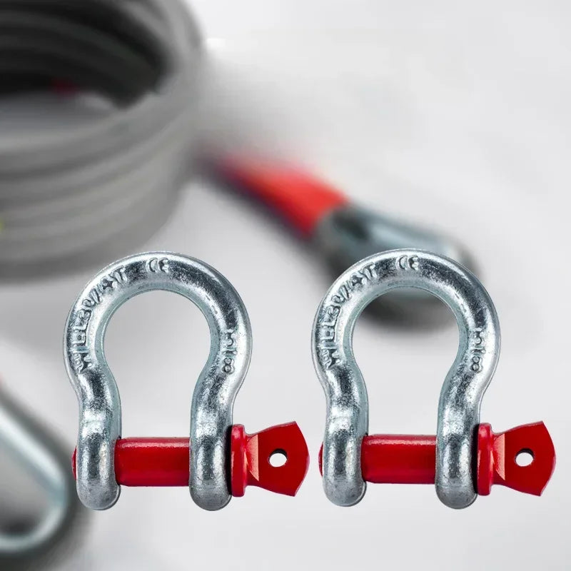 A pair of silver steel hooks attached to red plastic components, used for heavy-duty off-road tow rope.