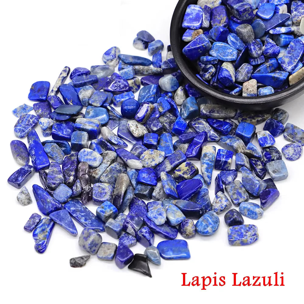 A pile of vibrant blue lapis lazuli crystal stone chips and tumbled stones.