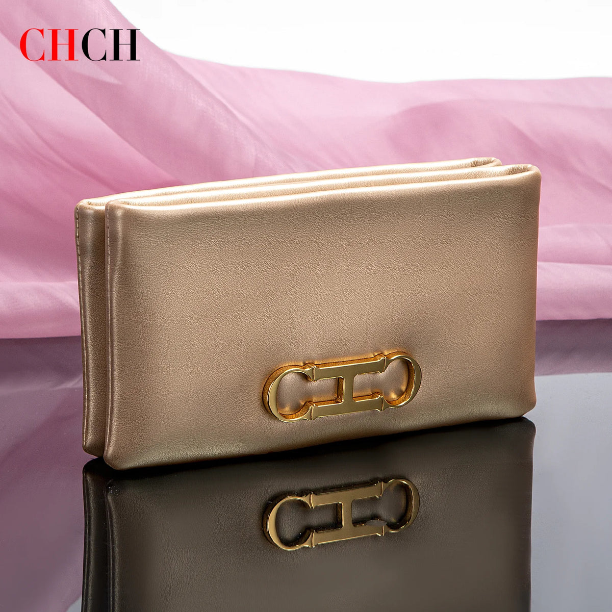 A beige leather compact zipper wallet or clutch resting on a dark surface.