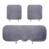 Three plush rabbit fur car seat cushions in varying sizes and shapes.
