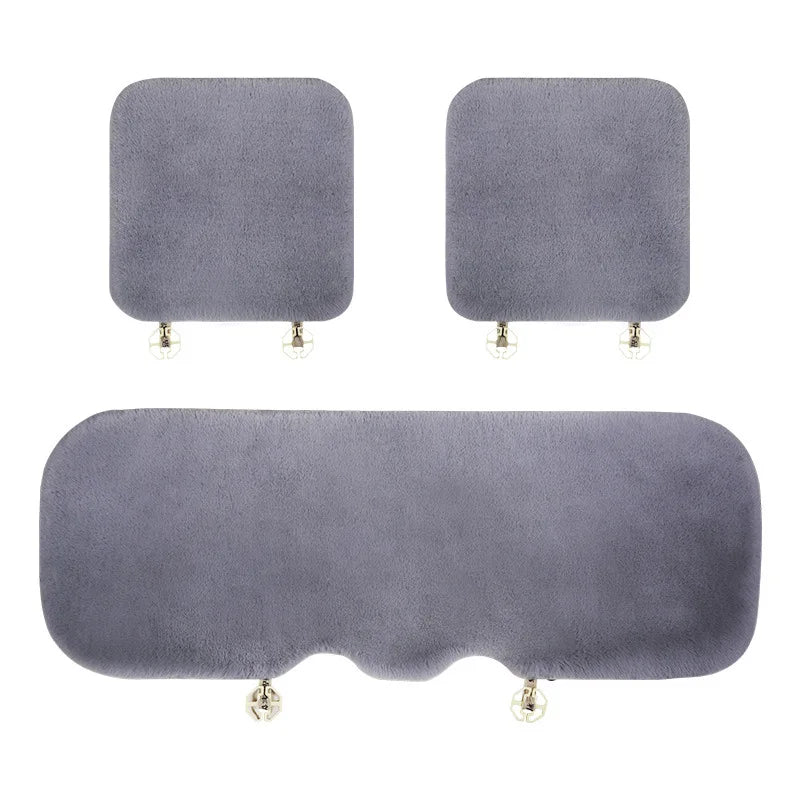 Three plush rabbit fur car seat cushions in varying sizes and shapes.