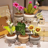 A collection of cute artificial flower plush dolls in various shades of green and pink, displayed on a white surface.