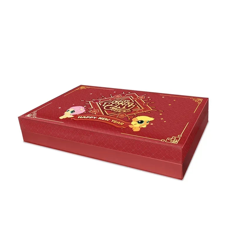 A red gift box for My Little Pony Friendship Eternal Radiant Moon Gilded Card Pack featuring a festive design.