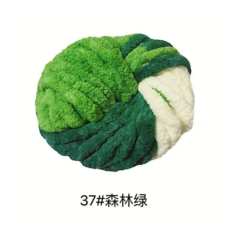 A head of green cabbage made from chunky acrylic yarn for knitting and crochet.
