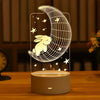 A glowing LED night light lamp shaped like a crescent moon with a rabbit silhouette on a wooden surface.