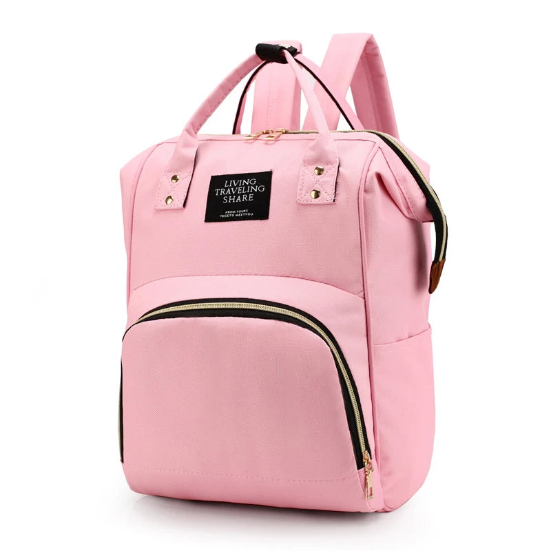 Pink insulated canvas mummy diaper bag with a hanging hook and zippered pockets