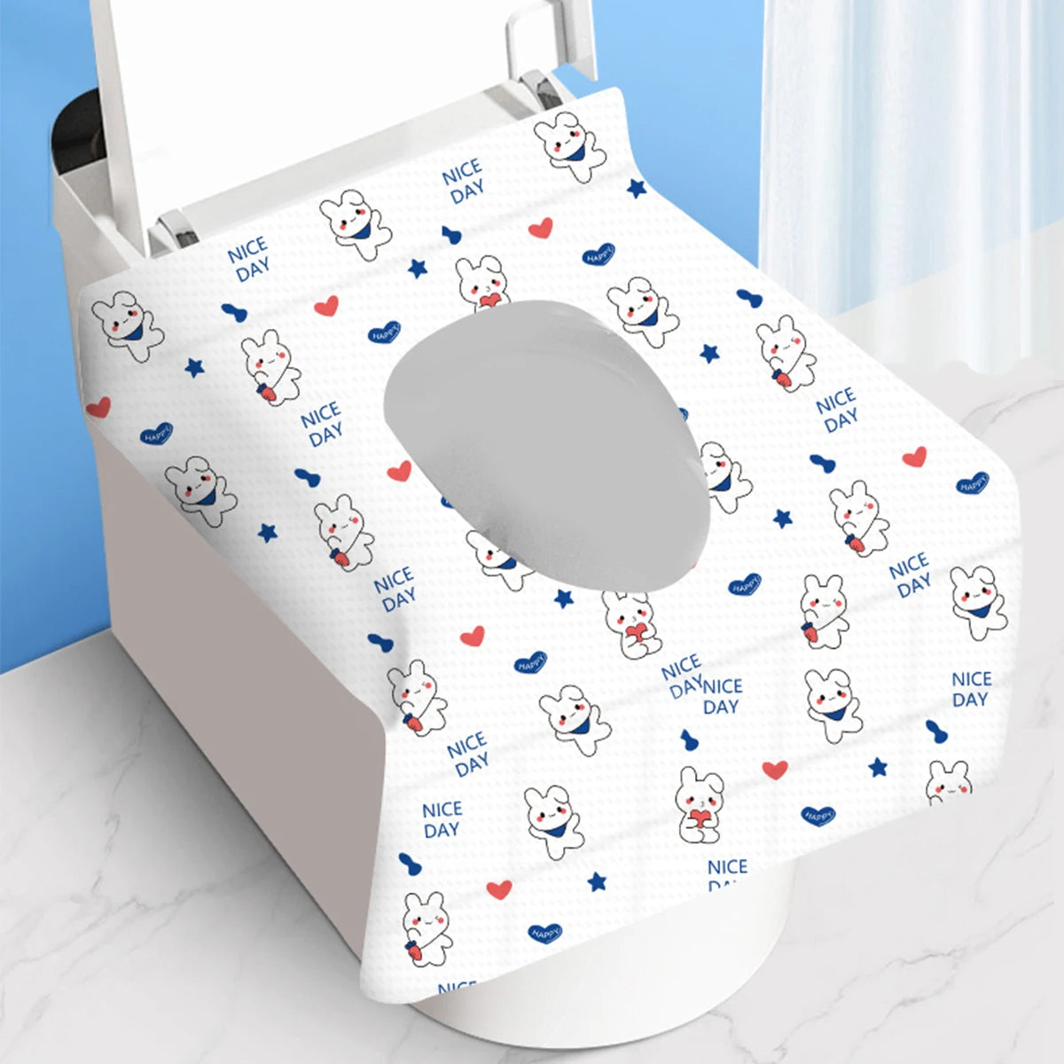 A white disposable toilet seat cover featuring repeated cute animal characters and the text Nice Day.