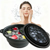 A woman is relaxing with a black silicone ice bath and facial massage bowl filled with ice cubes.