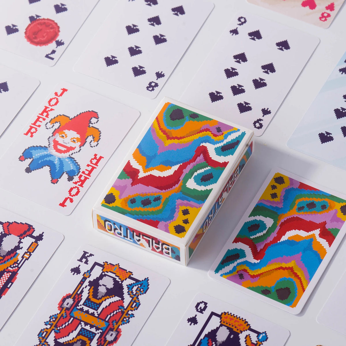 A close-up view of a classic poker card set featuring colorful, patterned cards and a box.