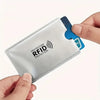 A hand holds an RFID protection card sleeve with a geometric pattern and a blue card inside.