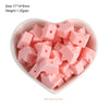 A bowl filled with pink silicone crown star heart beads for DIY jewelry making