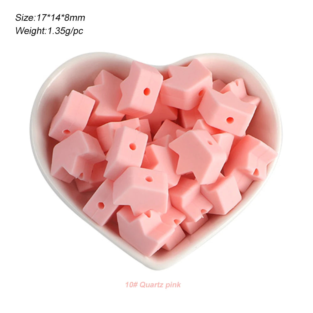 A bowl filled with pink silicone crown star heart beads for DIY jewelry making