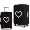 Black elastic suitcase protective cover featuring a white daisy print heart design.