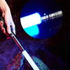 A hand holds a white lightsaber glowing with blue light, set against a dark background.