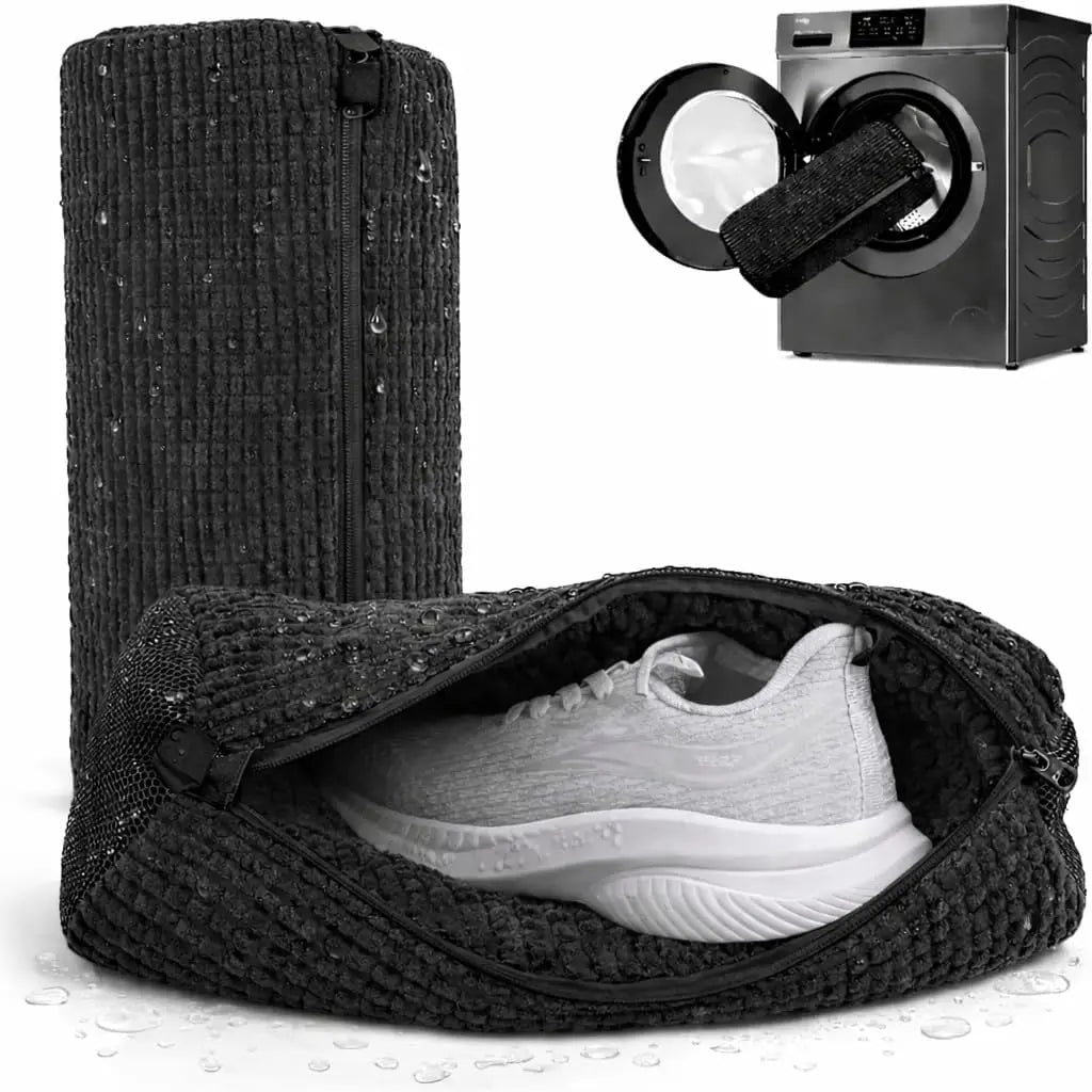 A black reusable shoe washing bag containing a white athletic shoe, next to a black and silver light box.