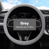 A grey universal silicone steering wheel cover is shown in a close-up view, ready for installation.