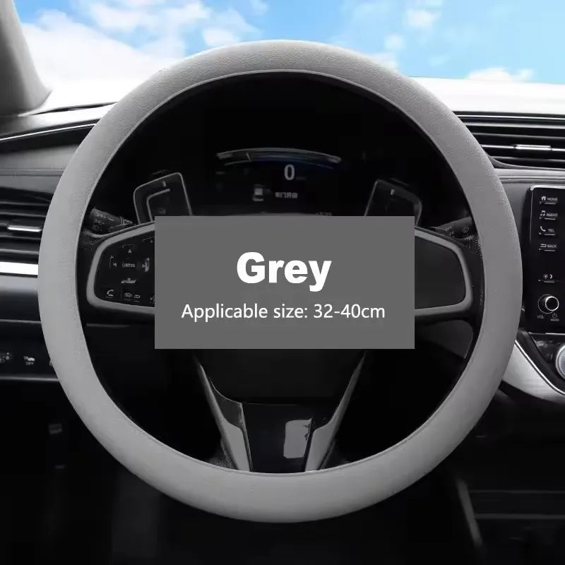 A grey universal silicone steering wheel cover is shown in a close-up view, ready for installation.