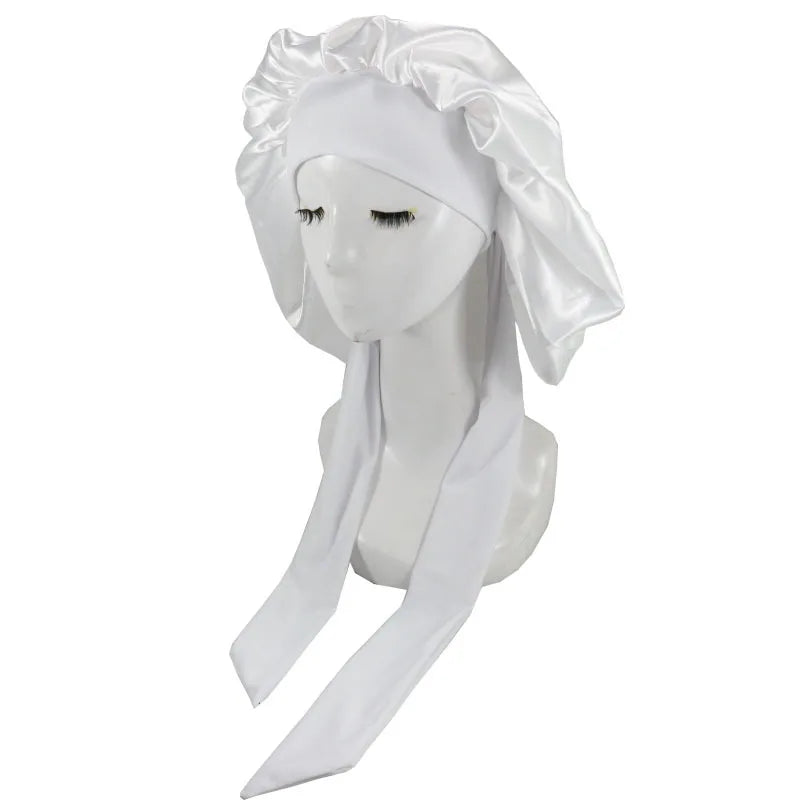 A white satin sleep cap for hair protection displayed on a mannequin head.