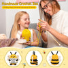 A woman is crocheting a bee figurine for a child, with examples of the finished crochet bees shown below.