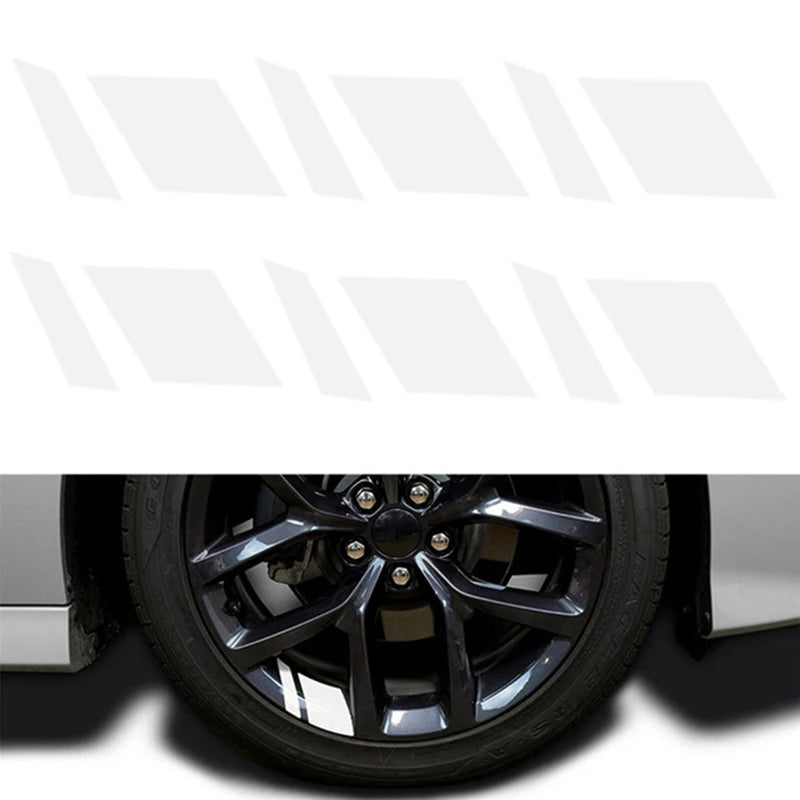 A close-up view of a black wheel hub with a reflective sticker set installed on the center cap.