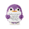 A purple crocheted penguin plush with a white sign that reads Positive penguin I may be a tiny penguin but I believe in you G