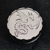 A silver metal coin featuring a detailed dragon design, used as a fingertip gyro roulette dice for tabletop games.