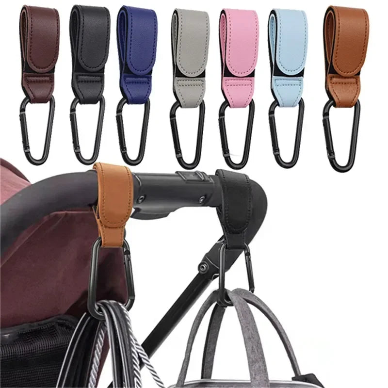 A set of colorful PU leather baby bag organizers with hooks shown next to a stroller handle.